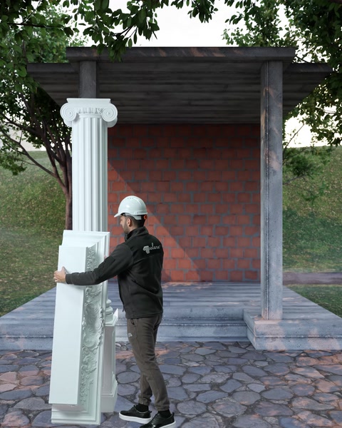 İşçi uzun oymalı bordür parçasını omuzda taşıyor
