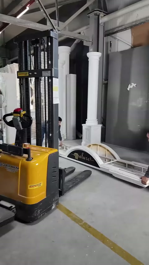Kaldırma aracının çatalları, zemindeki dekoratif parçaların yanında bekliyor.