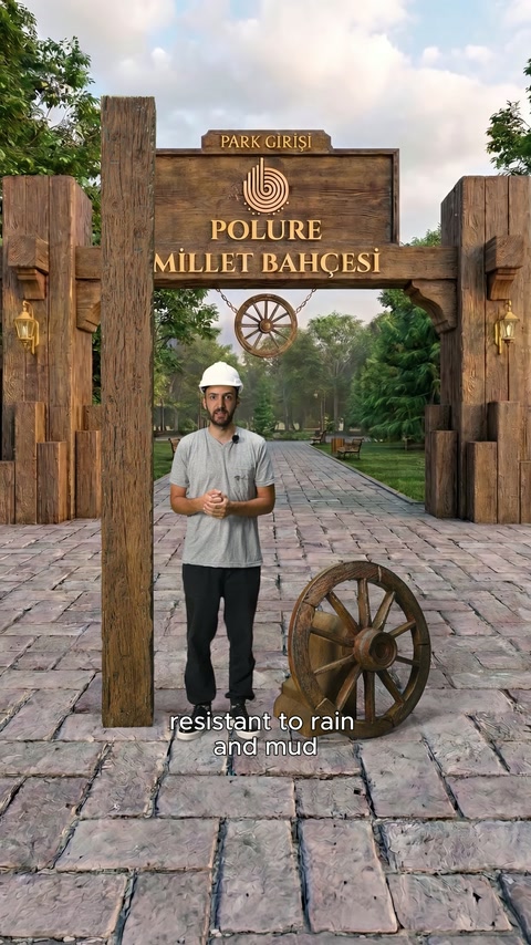 Park kapısının geniş görünümünde dekoratif kolonlar, tabela ve sunucu bulunuyor.