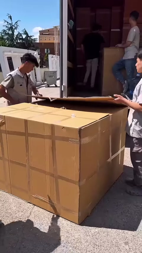 Bir çalışan kolinin üst kapağını geriye doğru kaldırıyor