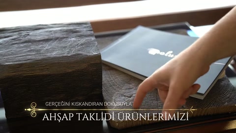 Parmak, ahşap desenli kiriş parçasının kenar detayına yöneliyor.