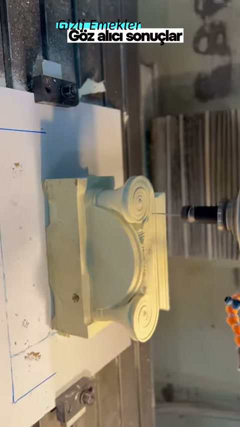 CNC tezgâhındaki açık renkli sütun başlığı yandan görüntüleniyor