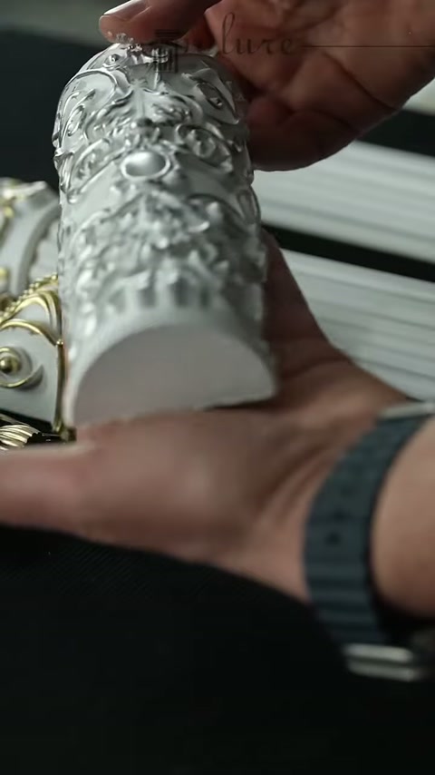 Metalik kaplamalı poliüretan süslemenin kavisli kesiti elde inceleniyor