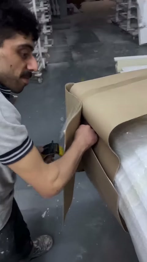 Sütun ambalajındaki bantlı bölüm yakın planda makasla kesiliyor