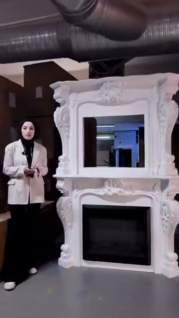 Sunucu süslemeli şömine modelinin solunda izleyiciye bilgi veriyor