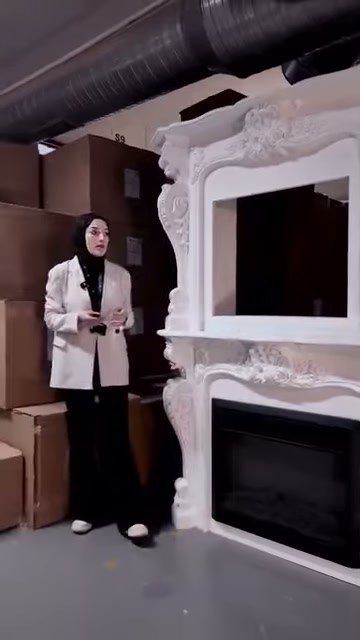 Siyah hazneli dekoratif şöminenin kabartmalı yüzeyi karşıdan görüntüleniyor