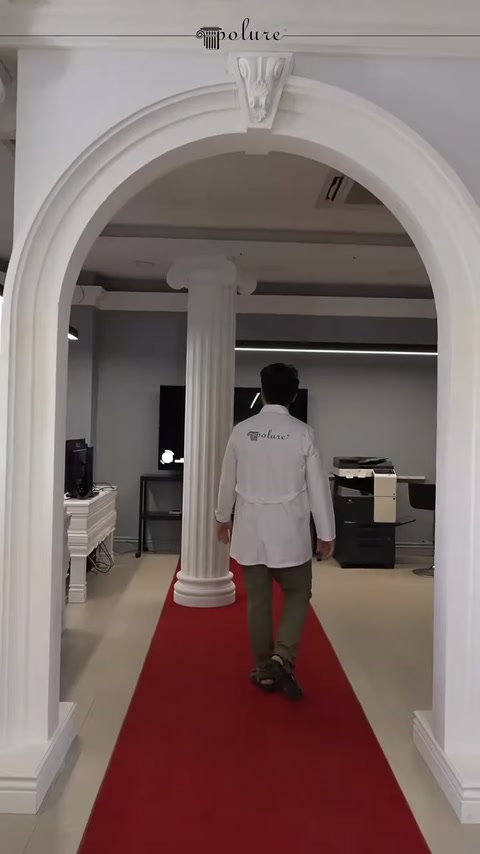 Beyaz kemerin altındaki yivli sütun showroom geçişini belirginleştiriyor